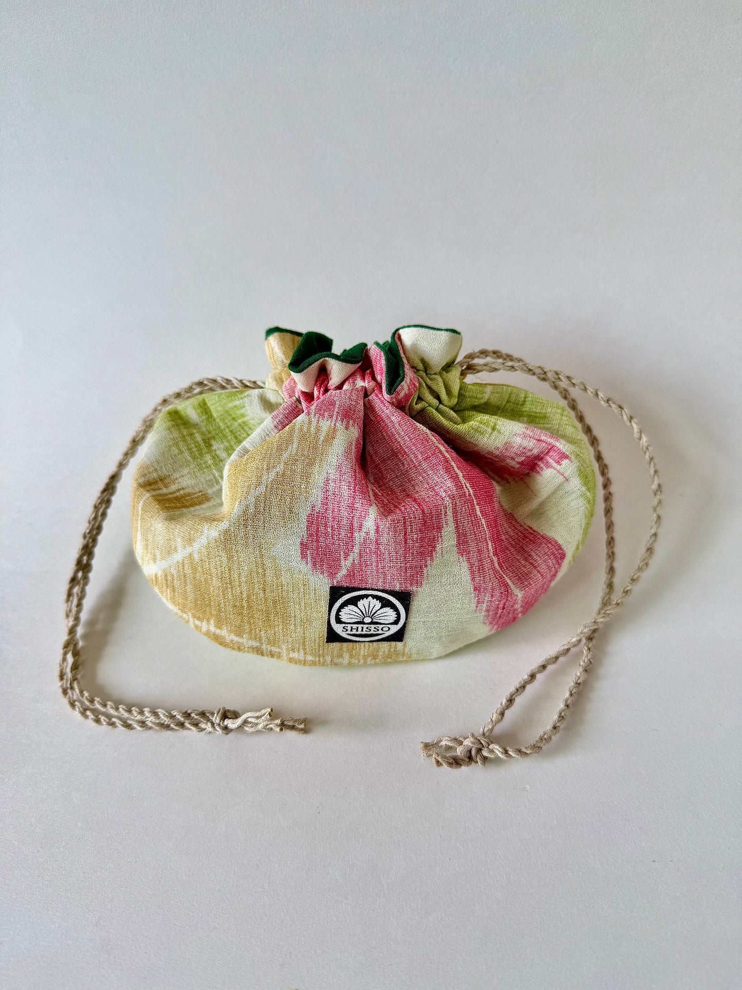 Beige woven kimono silk drawstring bag with green yellow and red momiji pattern