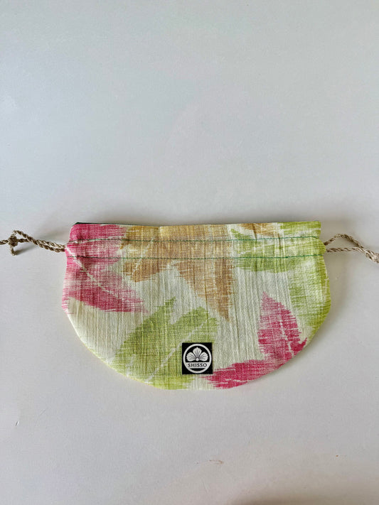 Front view of flat laying kimono sha silk drawstring pouch with autumnal Japanese maple leaf design