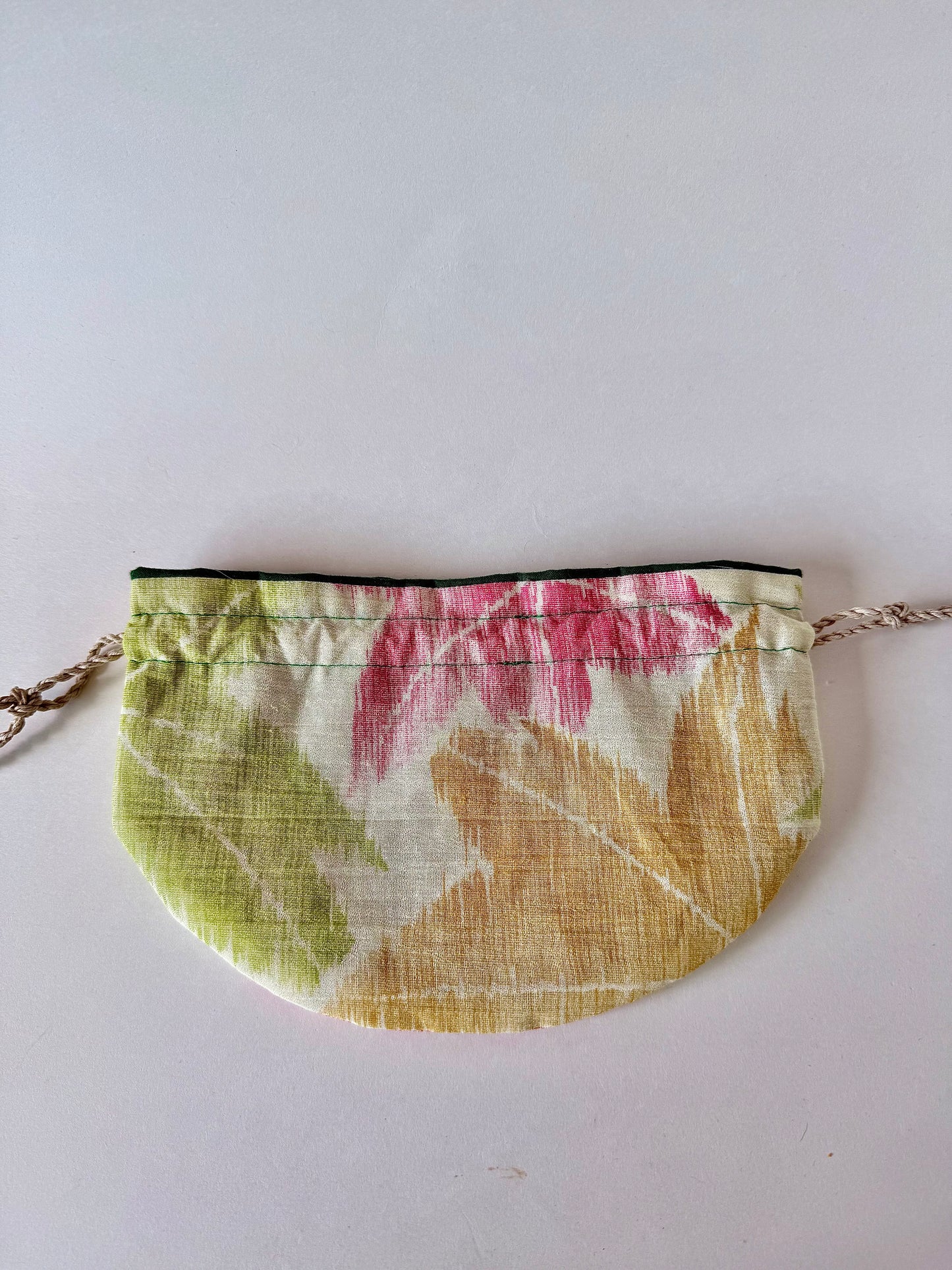 backside view of beige woven kimono sha drawstring bag laying flat