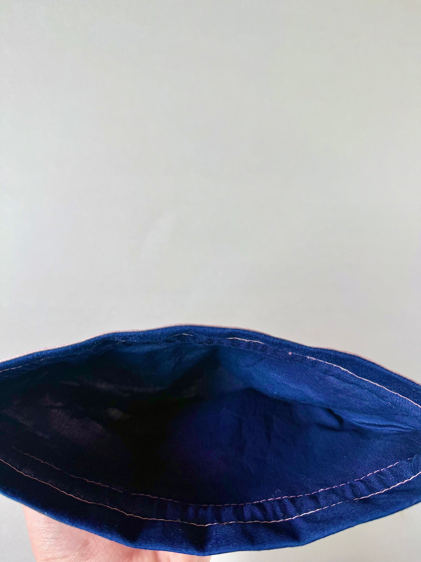 Interior view of light pink kimono silk drawstring pouch with navy cotton inner lining and pink stitching