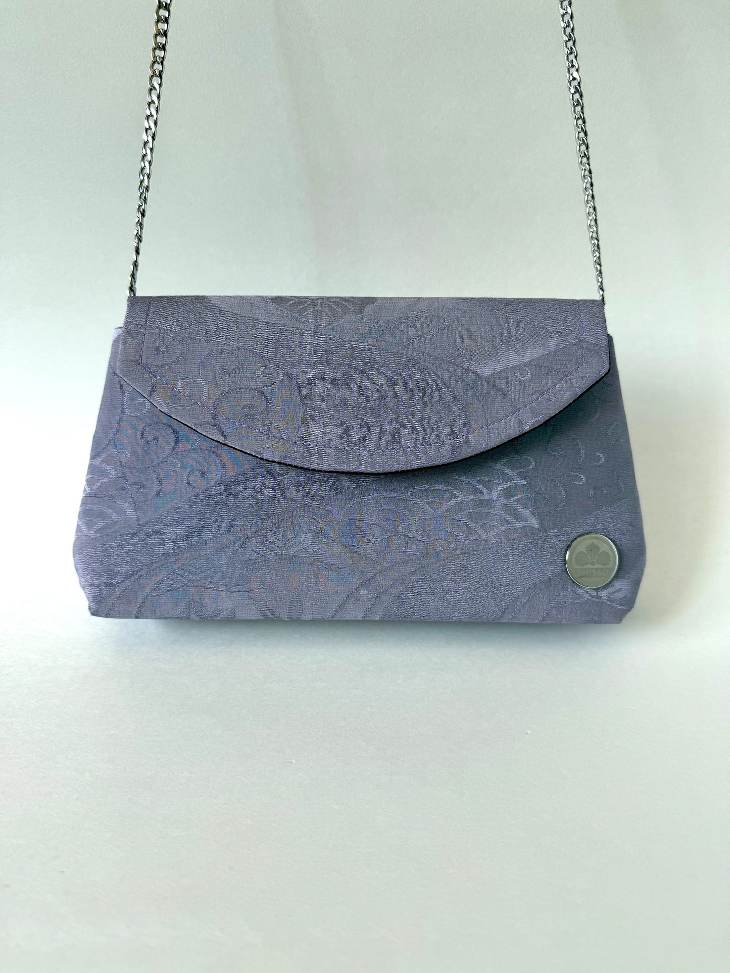 Purple chirimen silk clutch bag hanging from 48 inch metal chain link strap