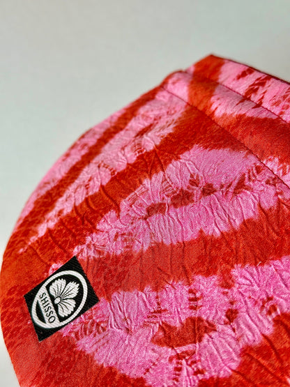 Close up view of red and pink kimono silk drawstring bag showing crepe and ripple texture in the fabric
