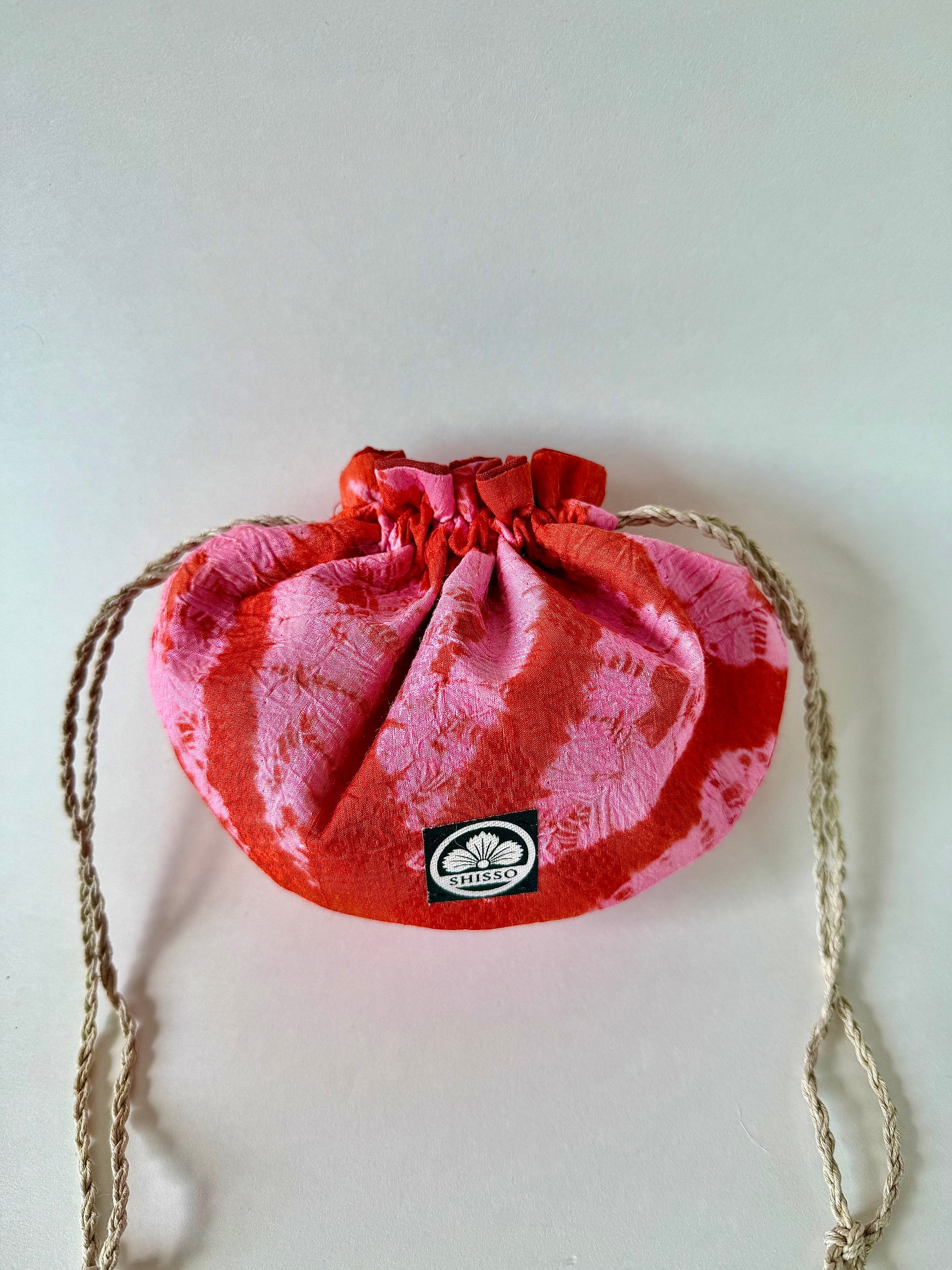red kimono silk drawstring pouch with pink and sheen accents and natural hemp drawstrings