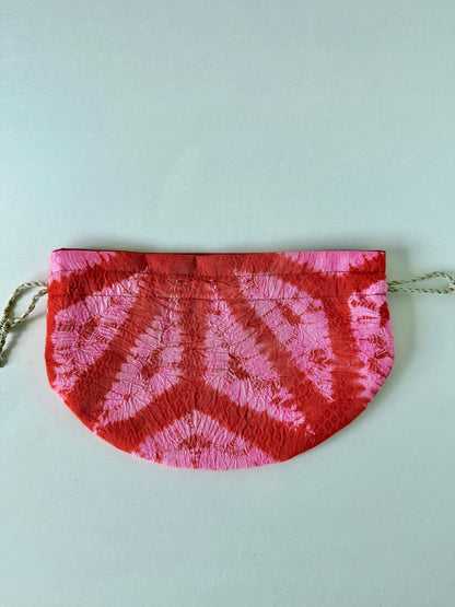 Backside of flat laying red and pink kimono silk drawstring pouch with 100% hemp drawstrings