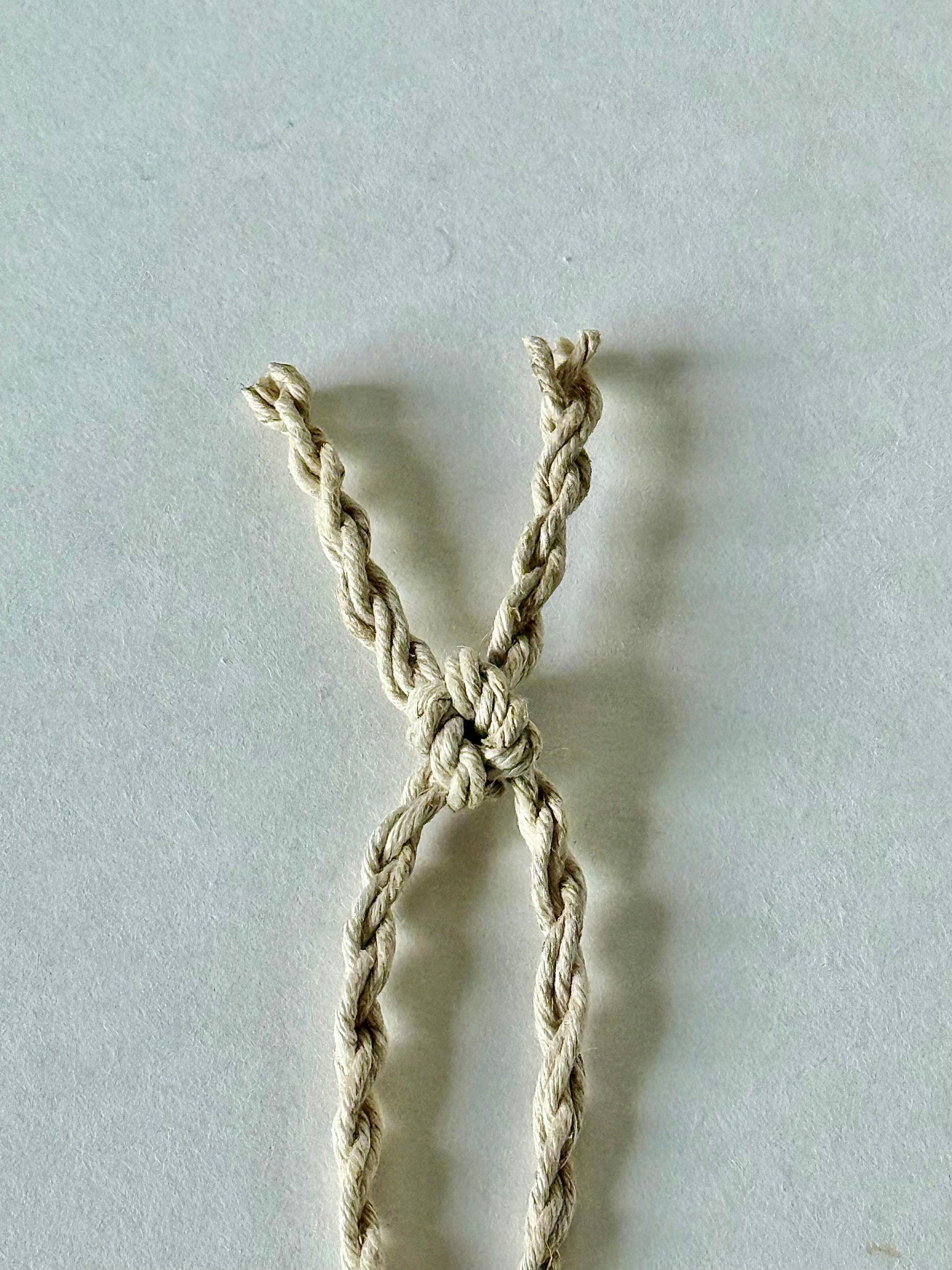 Hand twisted natural colored 100% hemp cord tied with a traditional Japanese square knot at the end