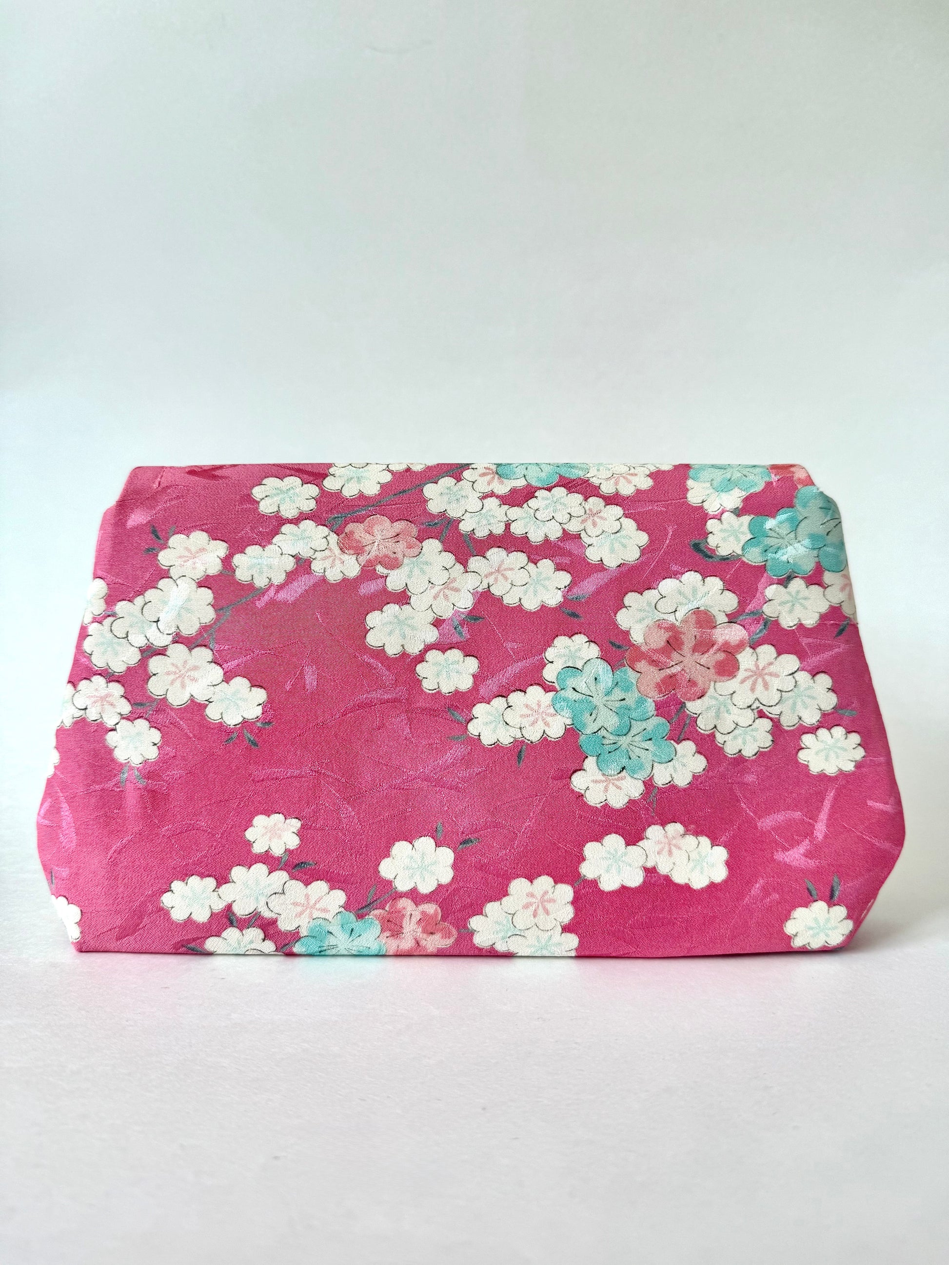 Back view of a clutch made from vintage 1960s kimono silk with white, pink, and blue cherry blossom motifs