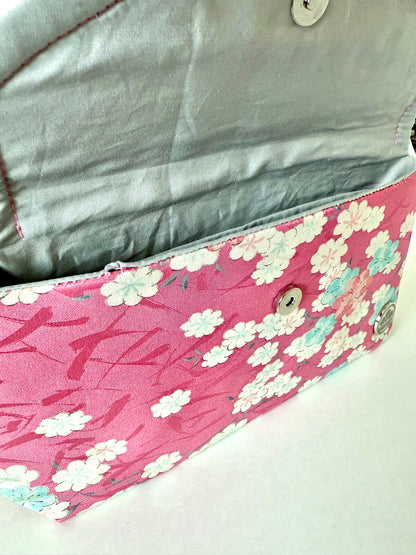 Close-up of hand stitched seam on vintage pink kimono silk with sakura motifs