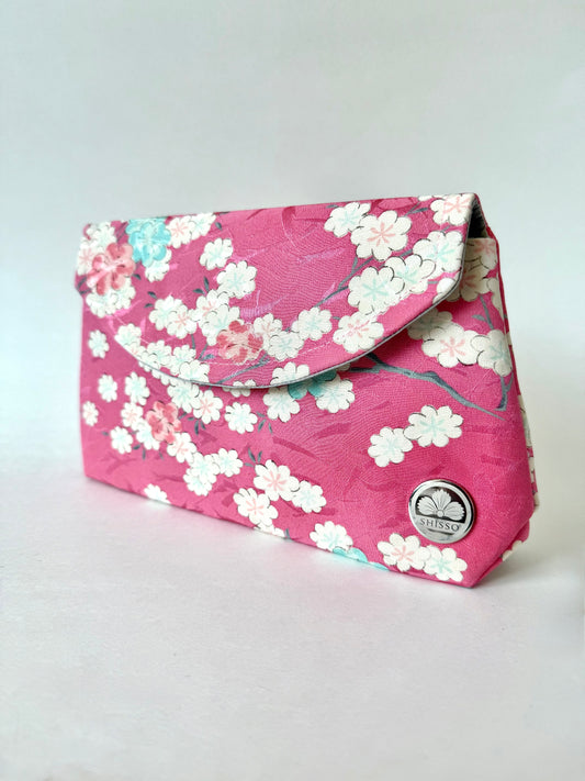 Angled view of pink kimono clutch bag with multi colored sakura pattern
