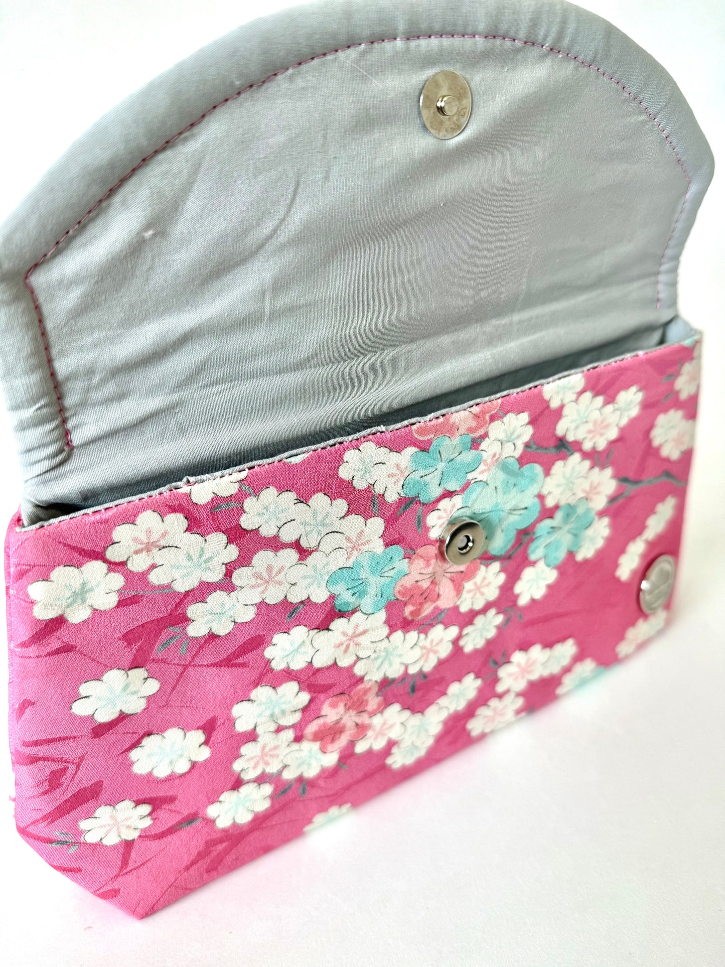 Close up of hand stitched seam on silk cherry blossom clutch bag