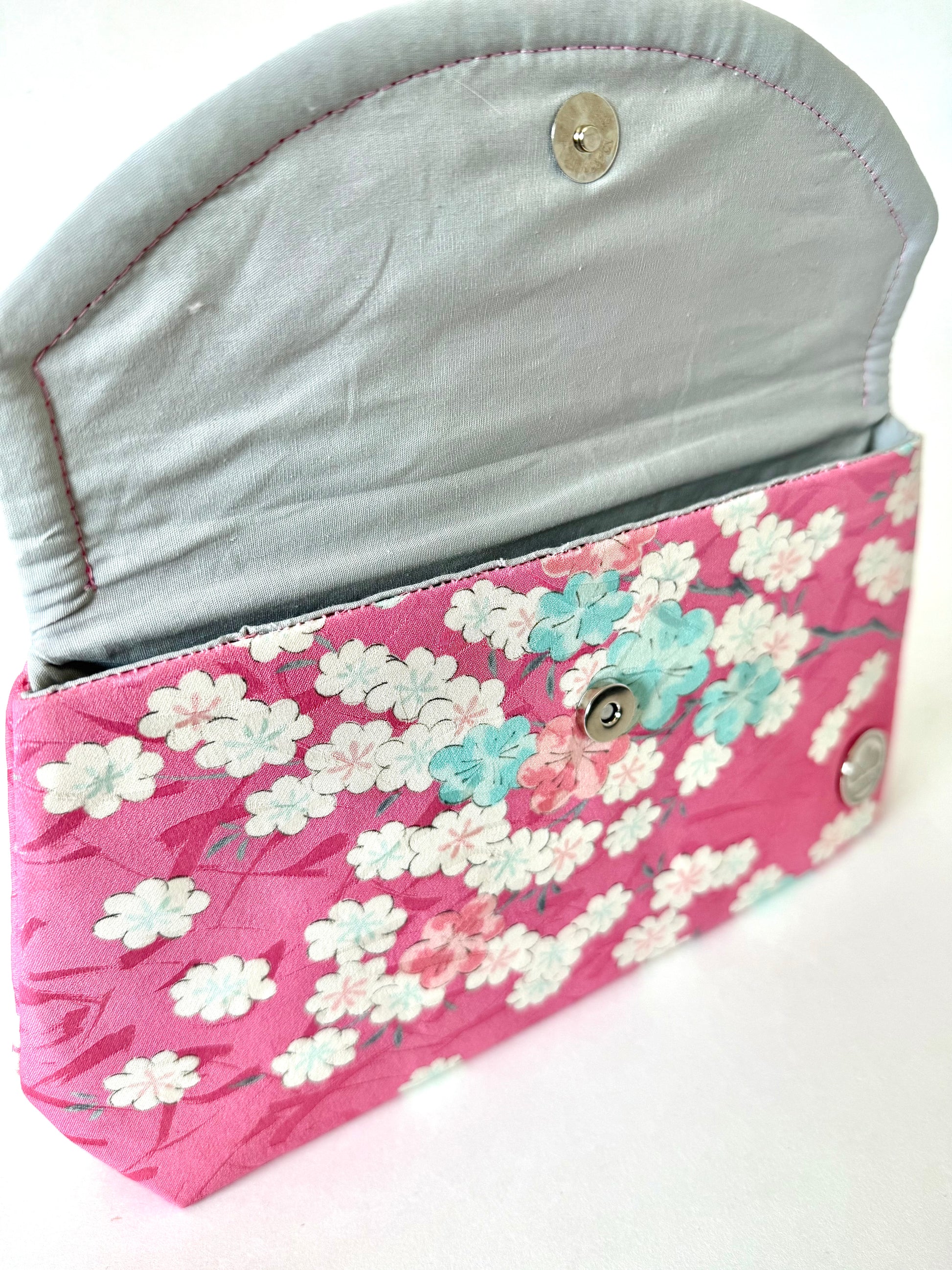 Close up of hand stitched seam on silk cherry blossom clutch bag