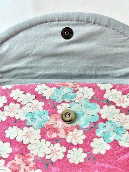 Magnetic closure of pink kimono silk clutch bag with silver cotton broadcloth interior