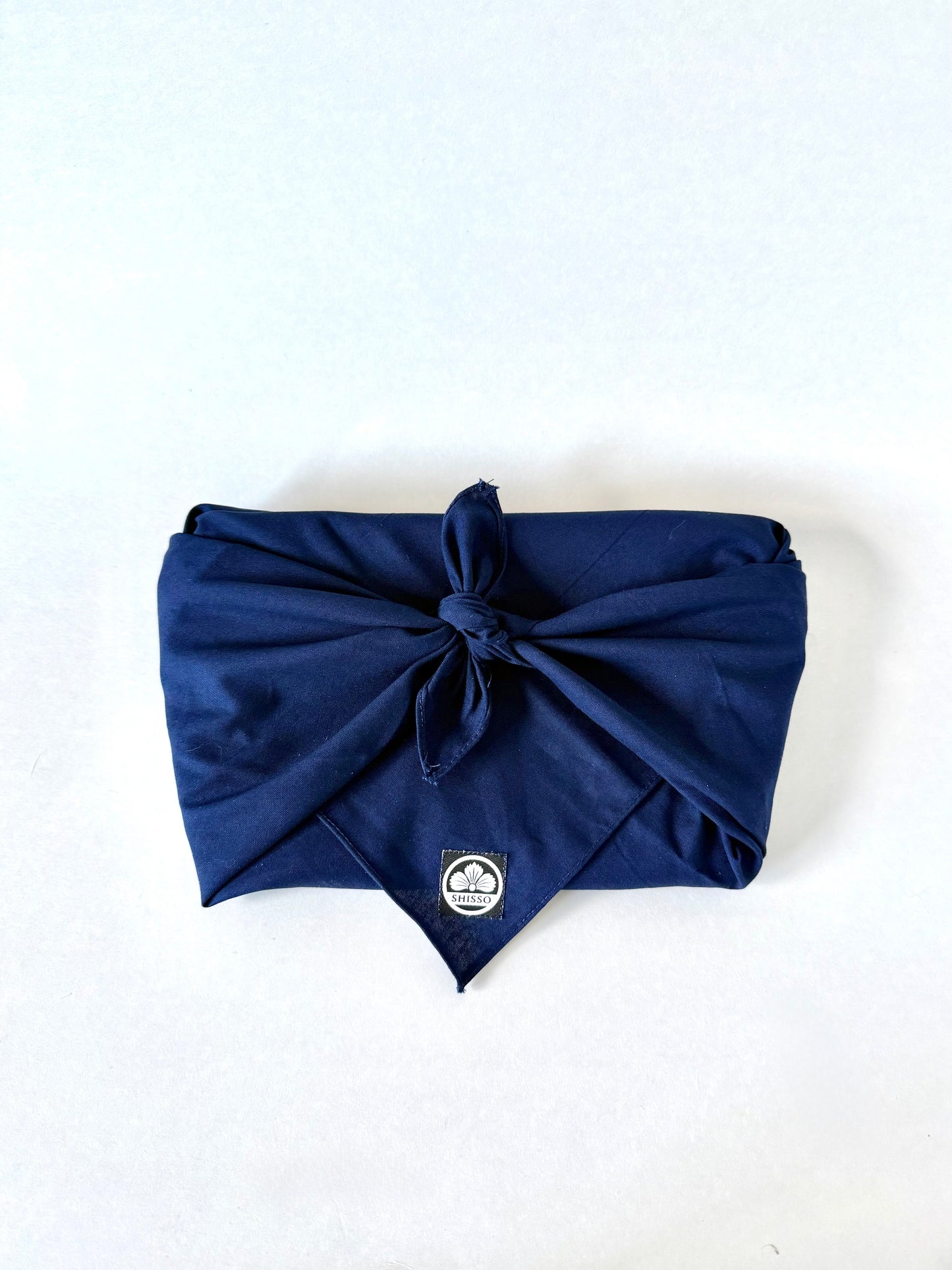 Shisso Clutch wrapped in traditional Japanese furoshiki cloth for sustainable packaging