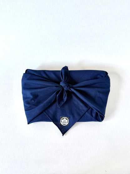 Shisso Clutch wrapped in traditional Japanese furoshiki cloth for sustainable packaging
