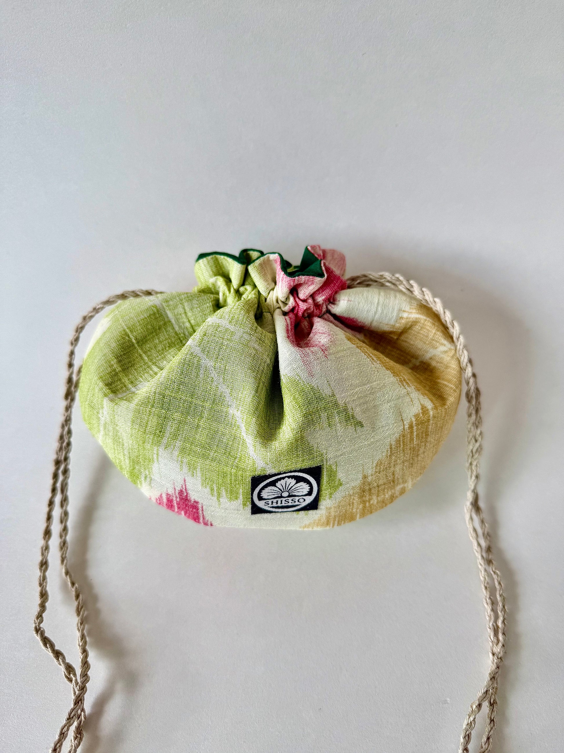 Off white kimono silk pouch with yellow, green, and red momiji pattern and natural hemp drawstrings