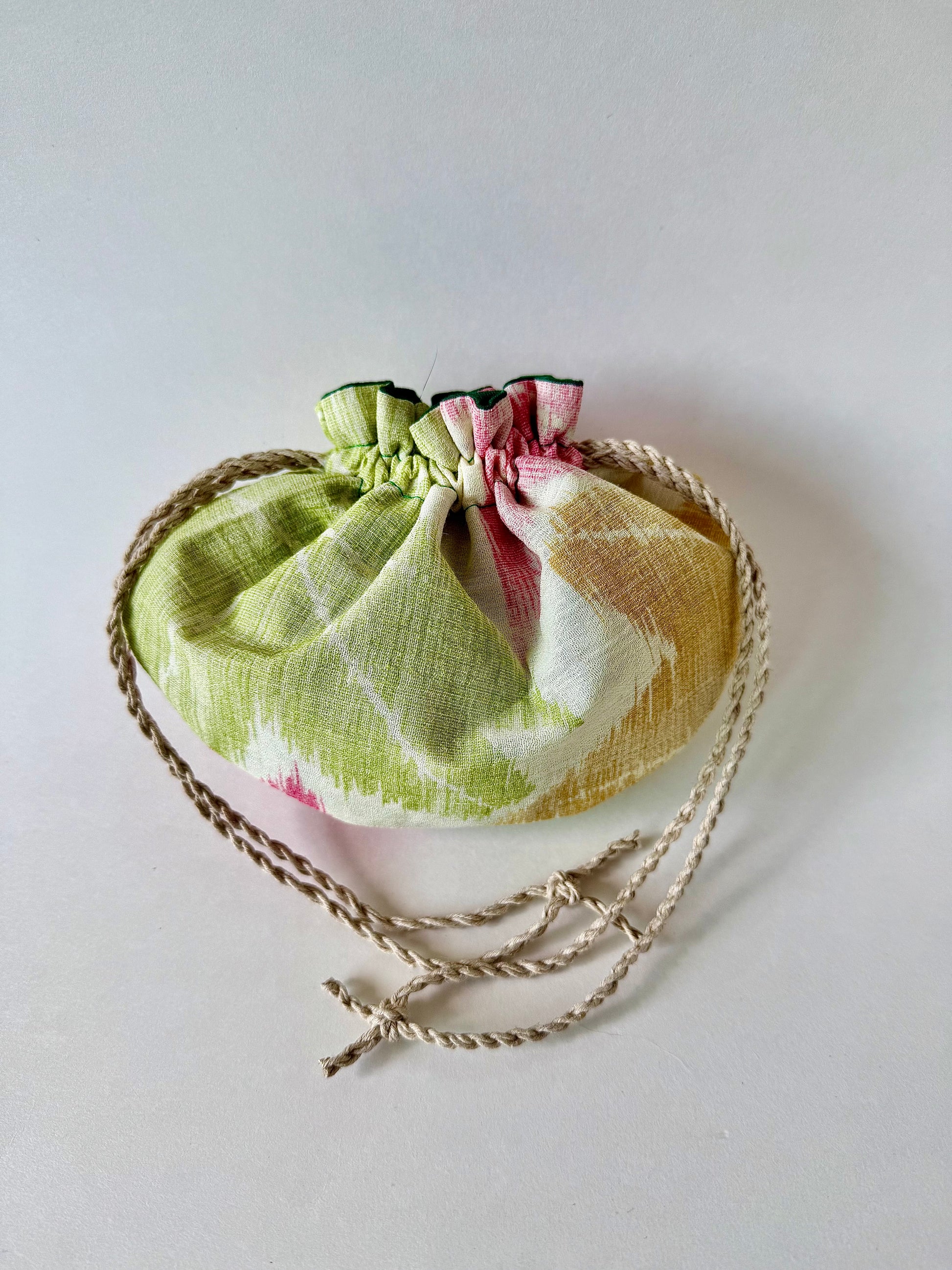 Back view of sha silk pouch cinched closed with natural hemp drawstring cords