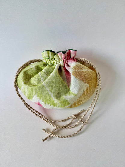 Back view of sha silk pouch cinched closed with natural hemp drawstring cords