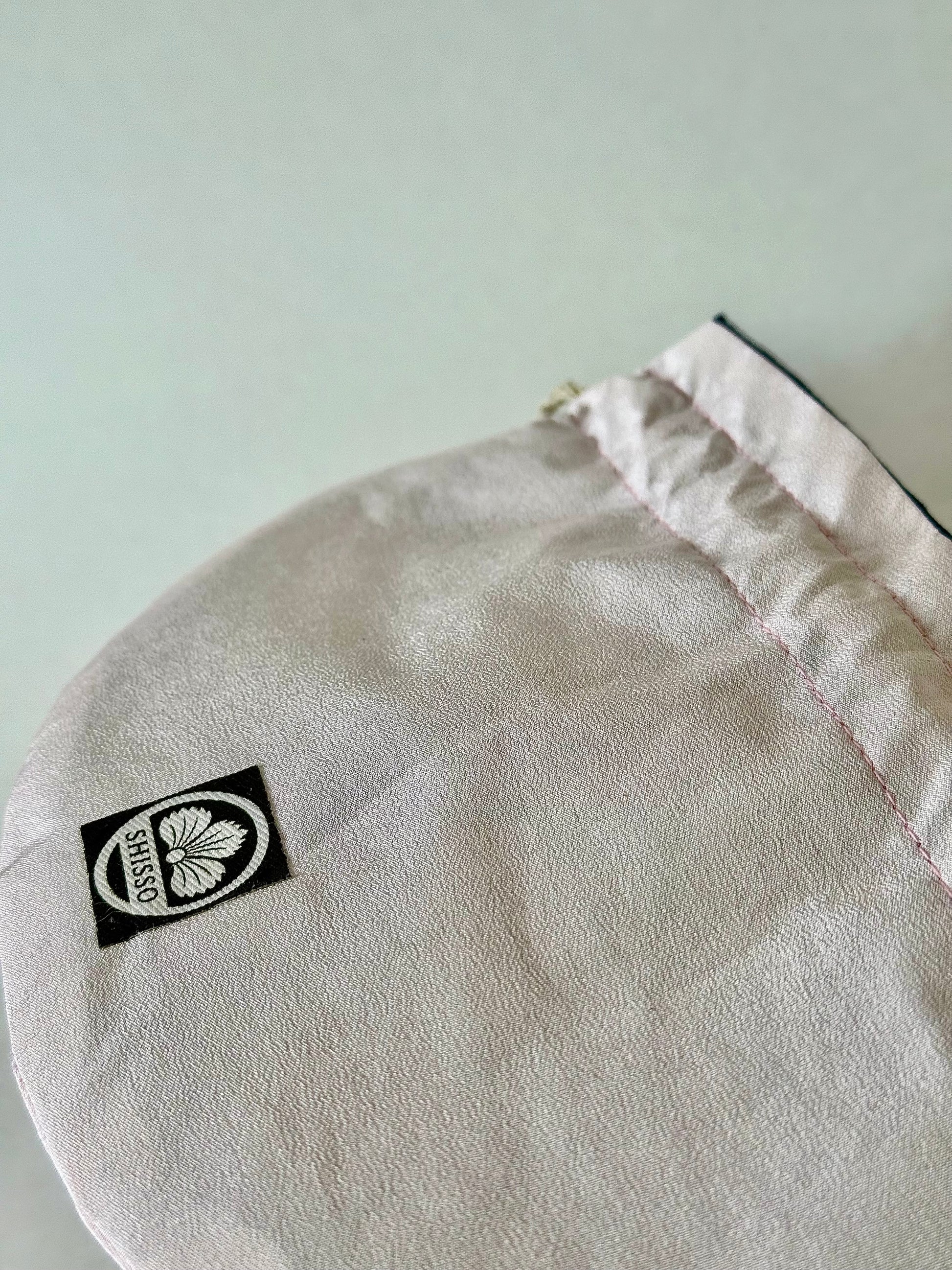 Close up of light blush pink kimono silk with slightly darker pink top stitching