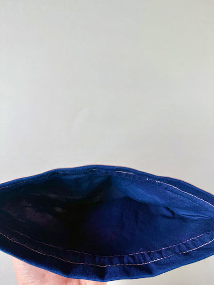 Interior view of light pink kimono silk drawstring pouch with navy cotton inner lining and pink stitching