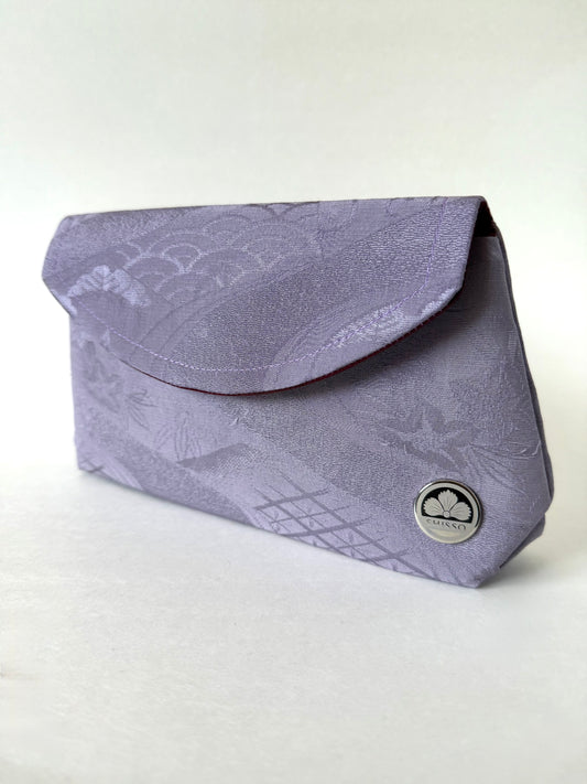 Front view of purple kimono silk fold over clutch featuring seigaiha and floral motifs