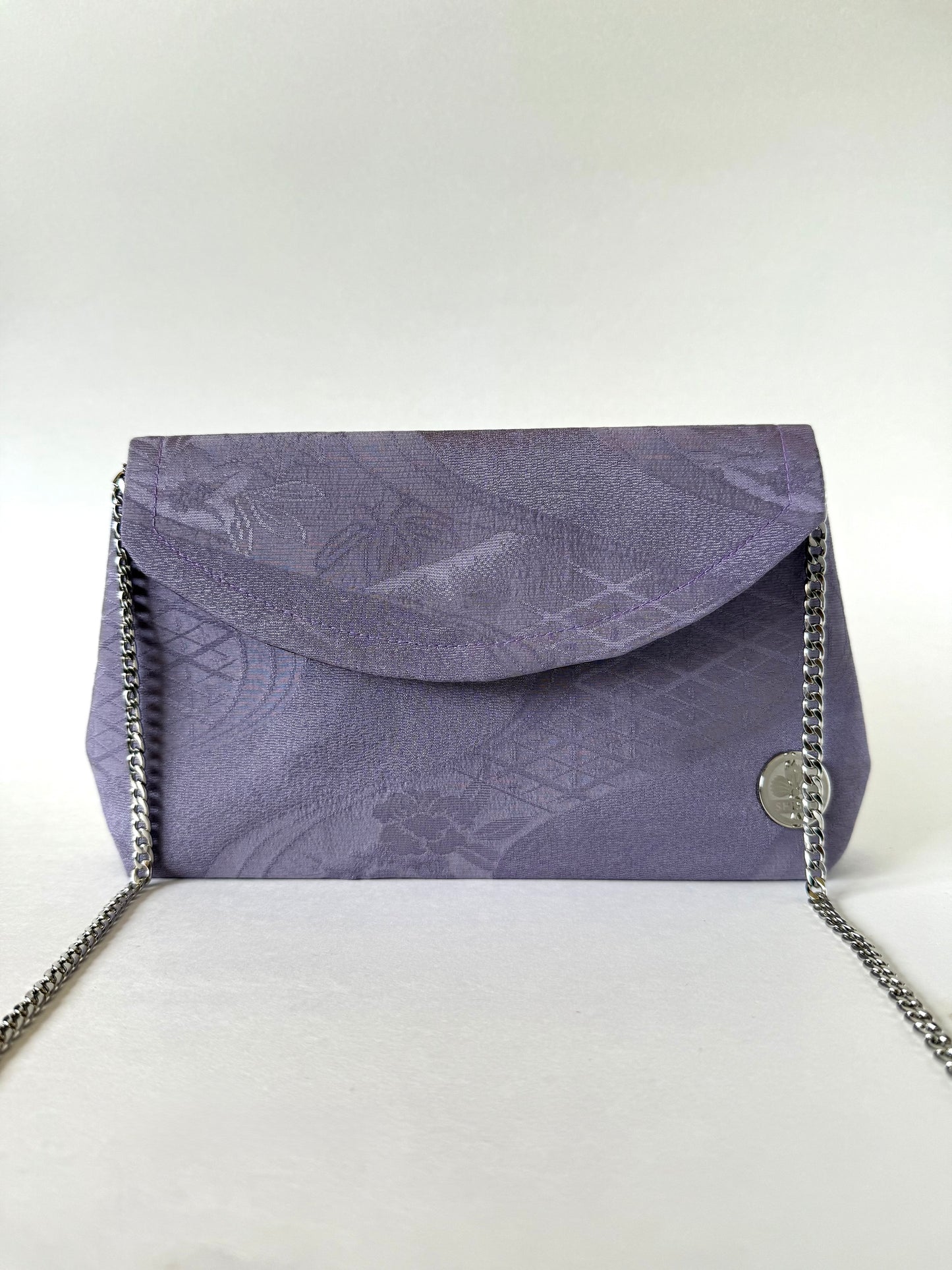 Purple kimono clutch with detachable 48-inch metal chain strap discreetly connected inside