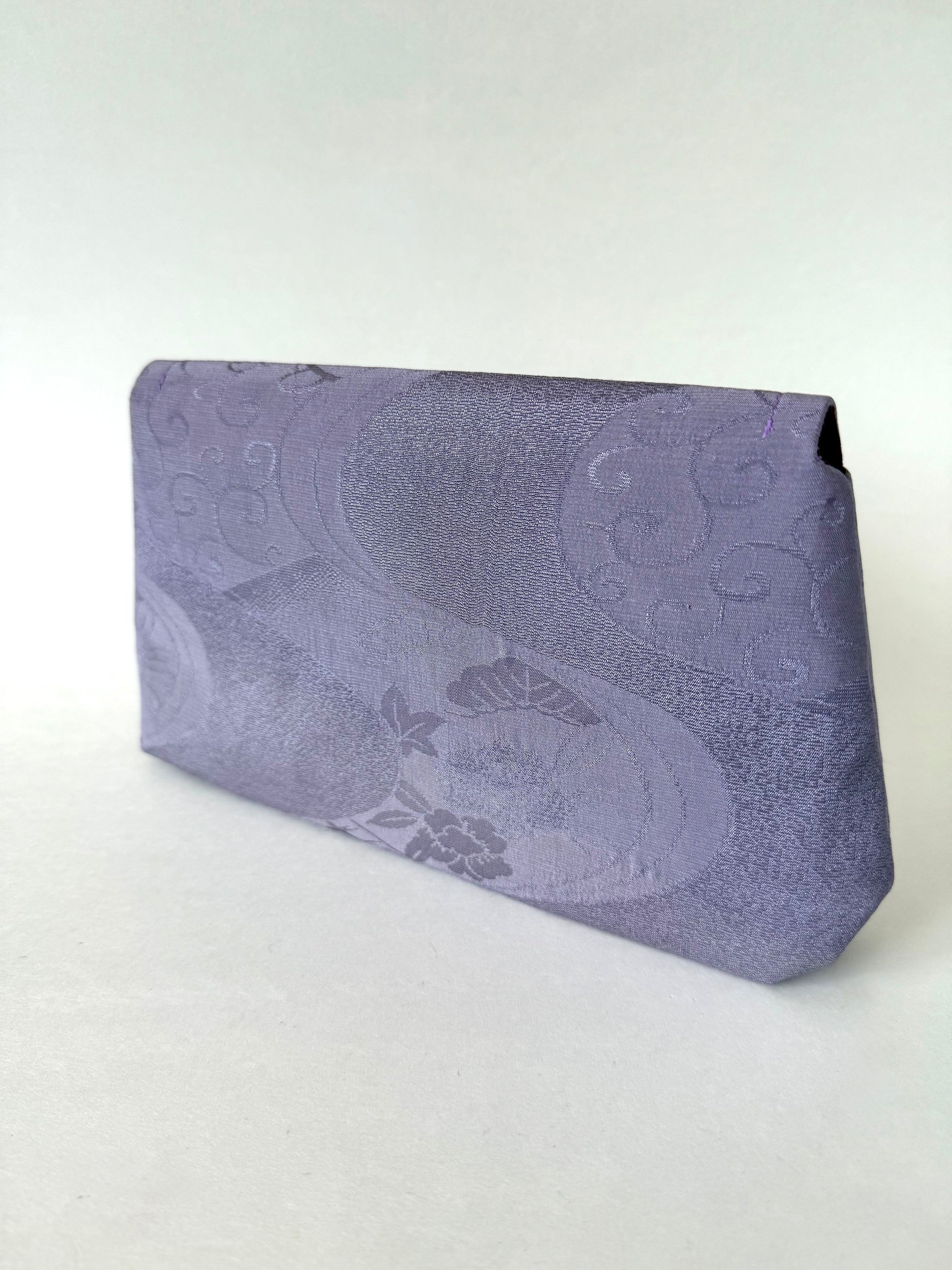 Back view of purple kimono silk clutch with wagara, floral, and river motifs