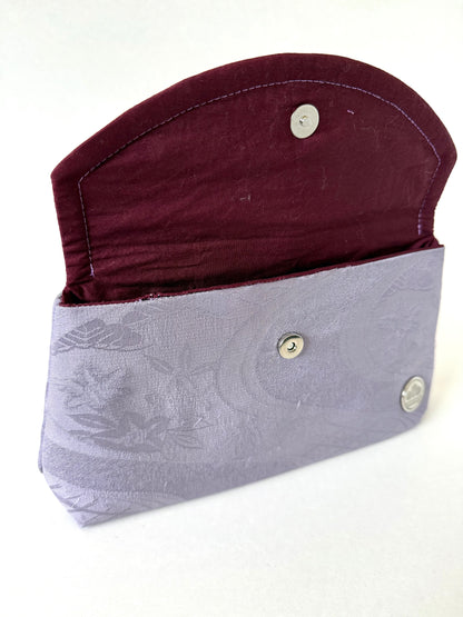 Purple kimono silk clutch bag with top flat opened showing a hand stitched seam and magnetic closure