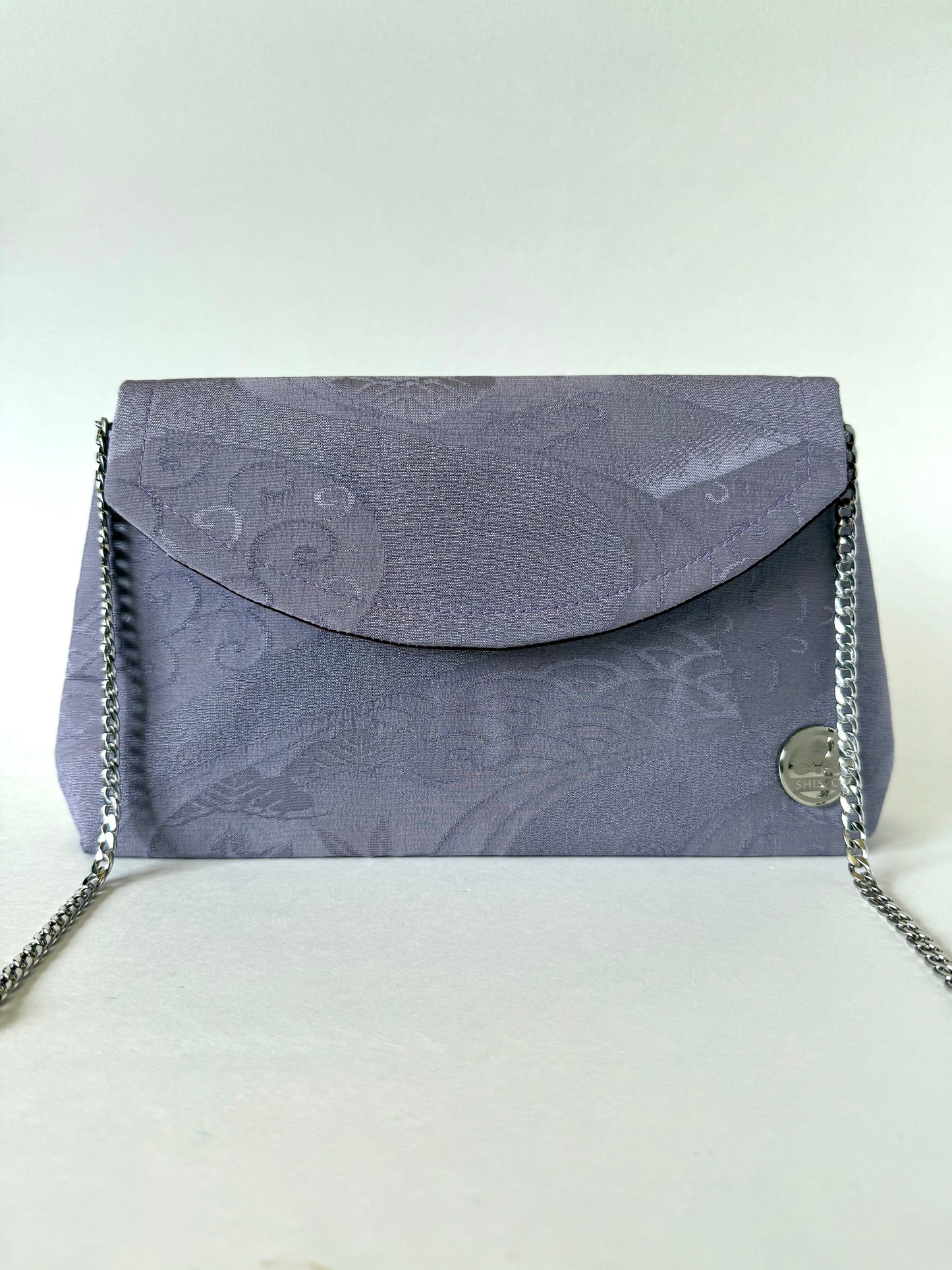 Front view of purple chirimen kimono silk foldover clutch bag with metal chain link strap