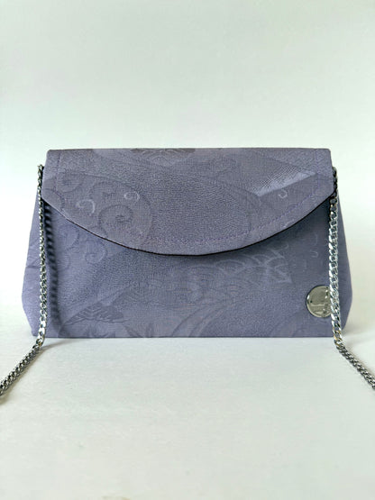 Front view of purple chirimen kimono silk foldover clutch bag with metal chain link strap