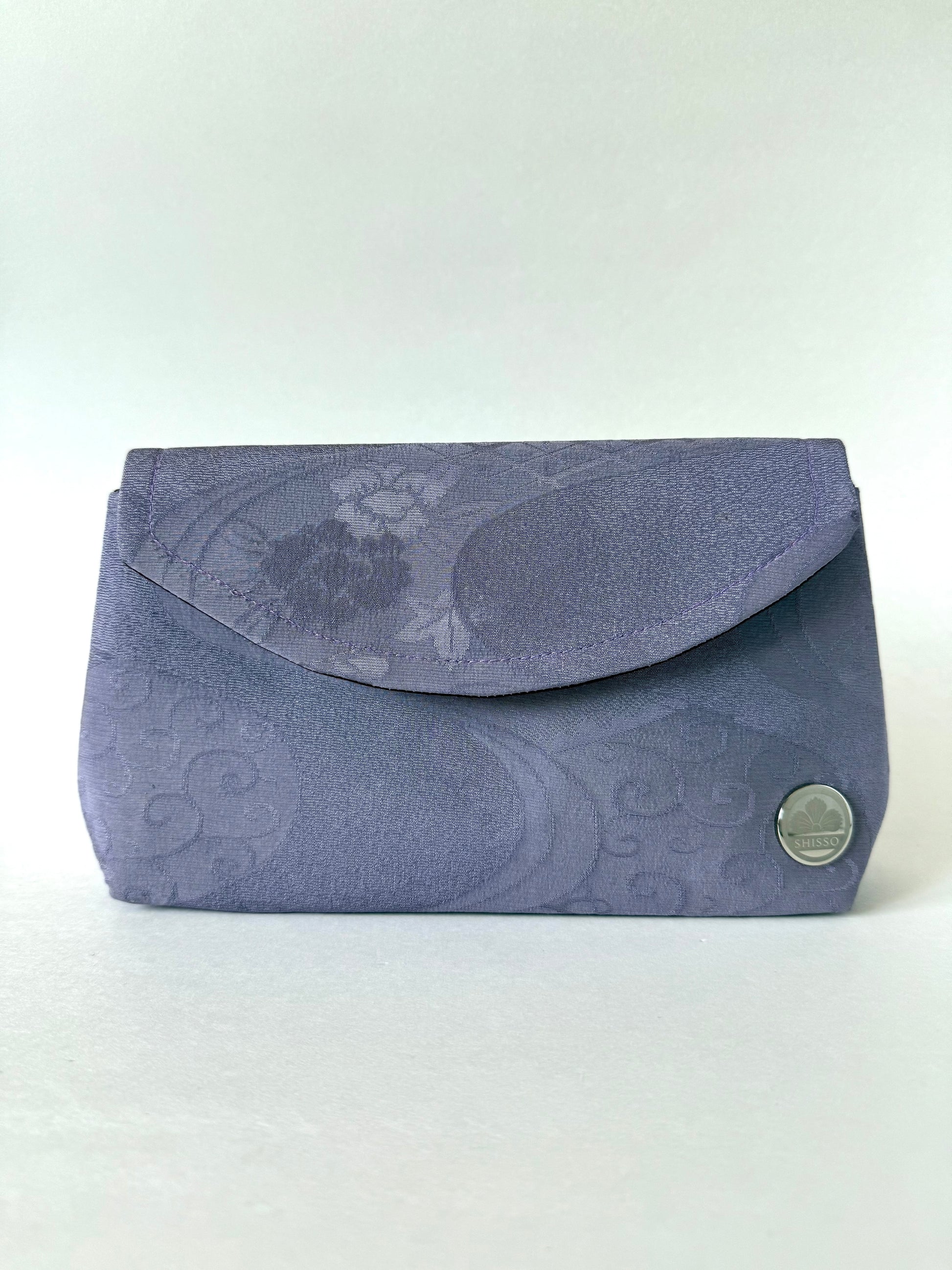 Front view of purple kimono silk clutch bag with subtle crepe texture and flowing water motifs