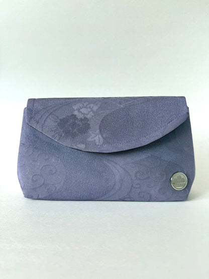 Front view of purple kimono silk clutch bag with subtle crepe texture and flowing water motifs