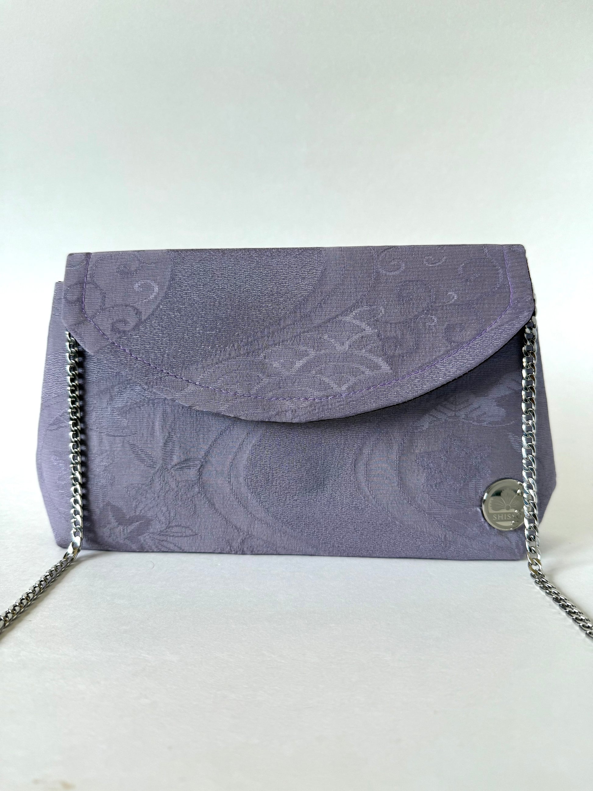 Front view of purple kimono chirimen silk clutch bag with thin metal chain strap