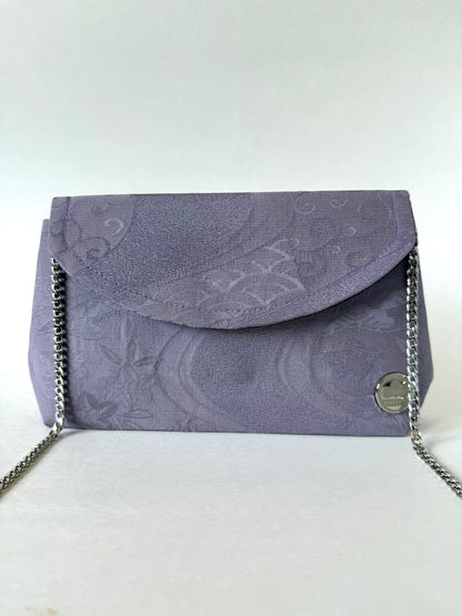 Front view of purple kimono chirimen silk clutch bag with thin metal chain strap