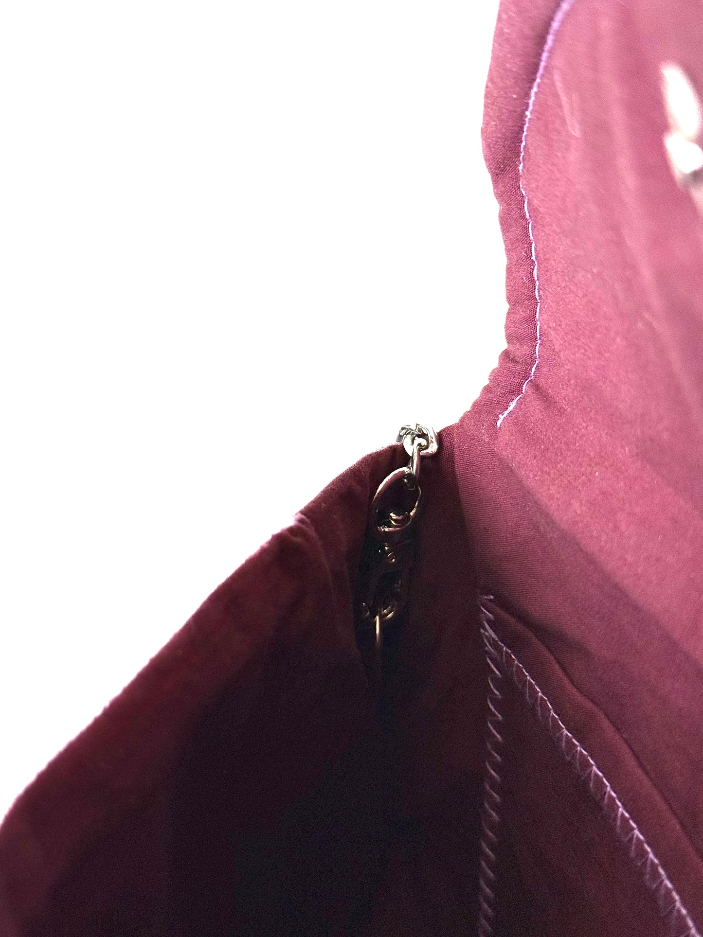 48 inch silver colored detachable metal chain strap connected to wine colored cotton broad cloth interior