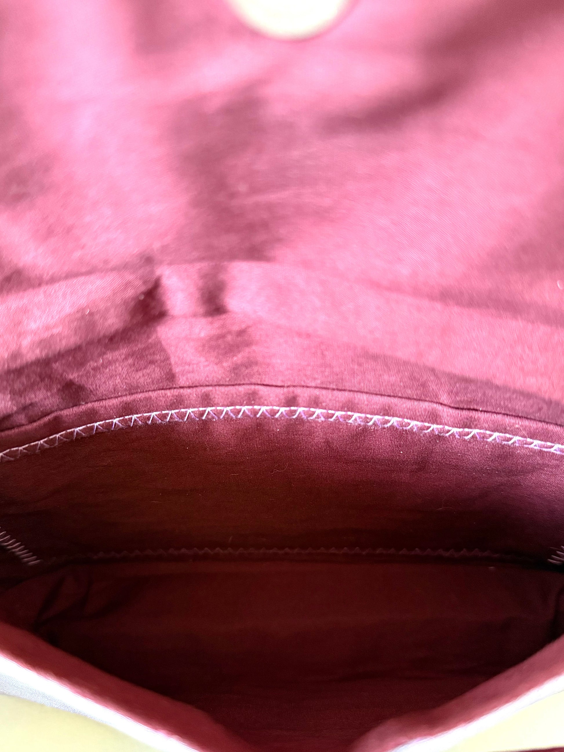Inside view of clutch with wine-colored cotton broadcloth lining and interior pocket