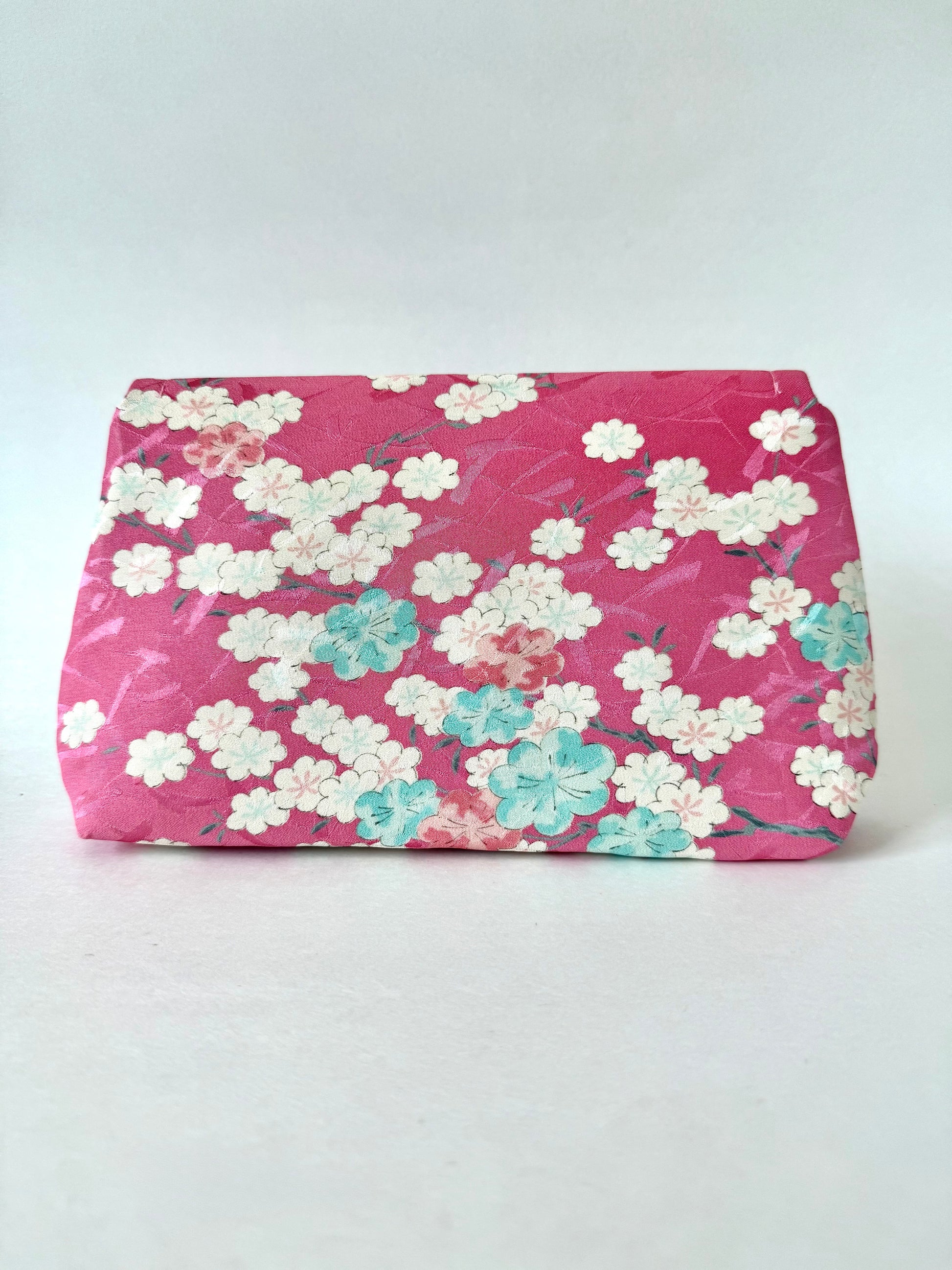Backside of pink kimono clutch bag with sakura branch and flower motif