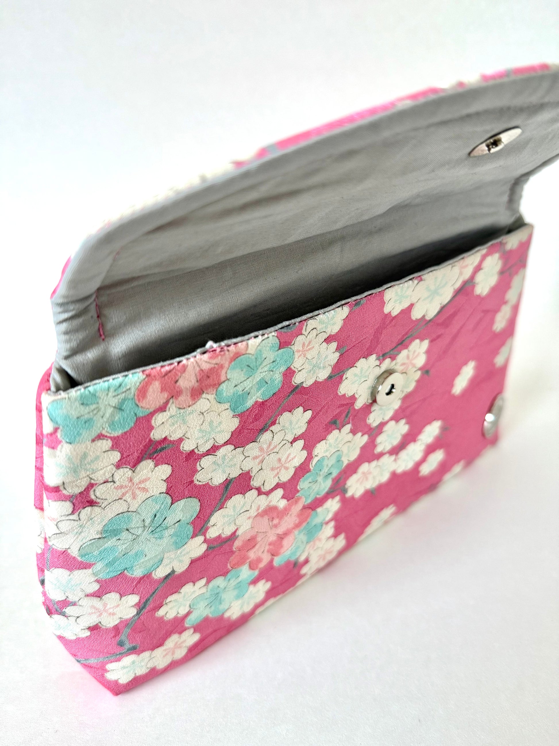 Pink hand stitched seam on silk cherry blossom clutch bag with magnetic closure