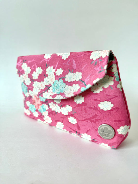 Pink kimono silk clutch bag with white, blue, and pink cherry blossom motif