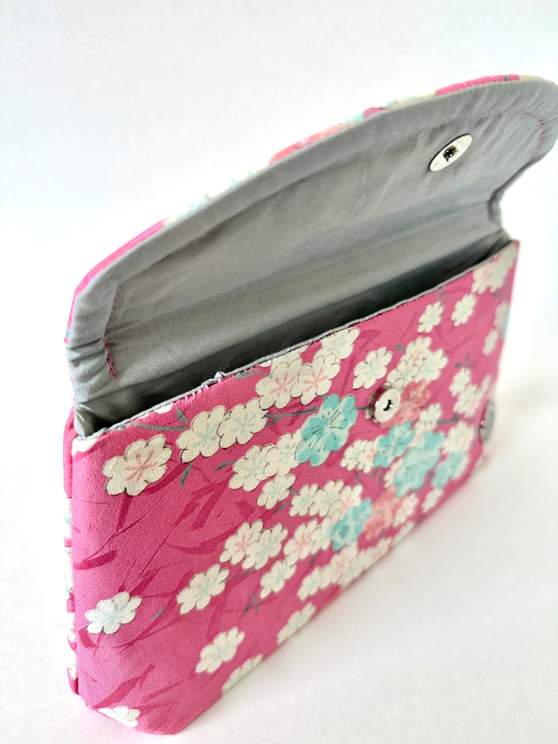 Hand stitched seam connecting silver cotton broadcloth interior to pink kimono silk exterior handmade clutch bag