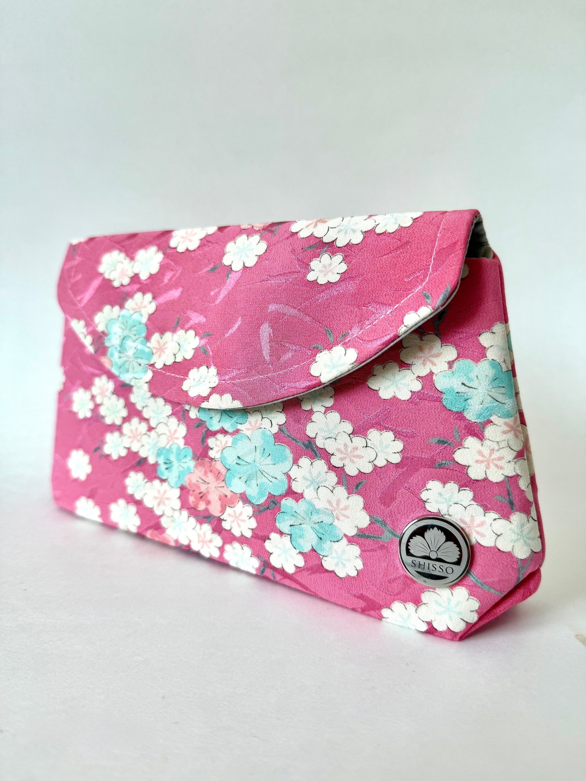 Pink kimono fabric fold over clutch bag with white, blue, and pink sakura flower motif