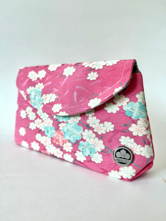 Pink kimono fabric fold over clutch bag with white, blue, and pink sakura flower motif
