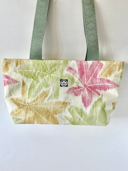 Beige kimono silk tote bag with red, yellow, and green momiji pattern hanging from dark olive green straps