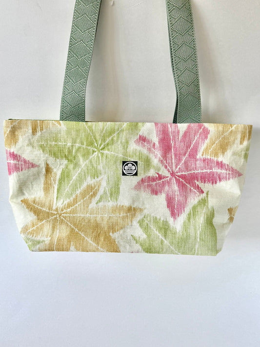 Beige kimono silk tote bag with red, yellow, and green momiji pattern hanging from dark olive green straps