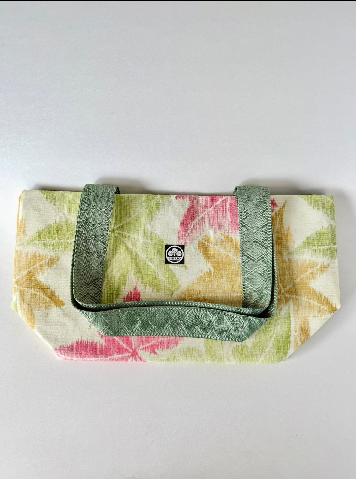 Flat lay of woven kimono silk tote bag with webbing handles folded on top