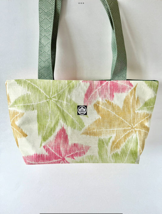 Woven kimono silk tote bag featuring muted red, green, and yellow momoji pattern and dark sage green straps