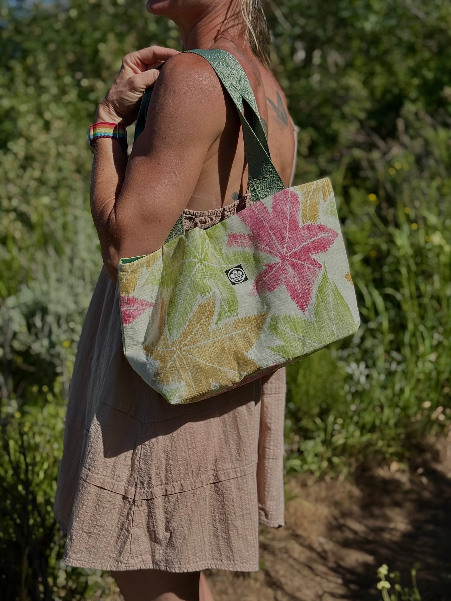 Shisso Carry Tote worn over the shoulder on a mountain trail, with kimono silk and webbing strap visible